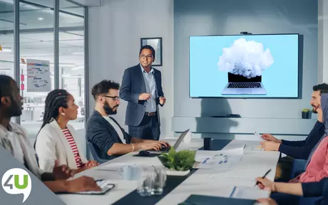 People in a boardroom looking at a screen