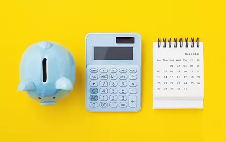 Piggybank, calculator and agenda 