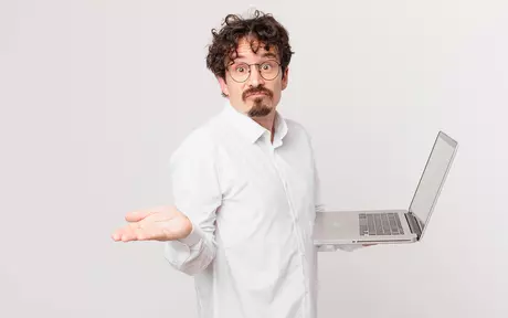 person confused with laptop in hand