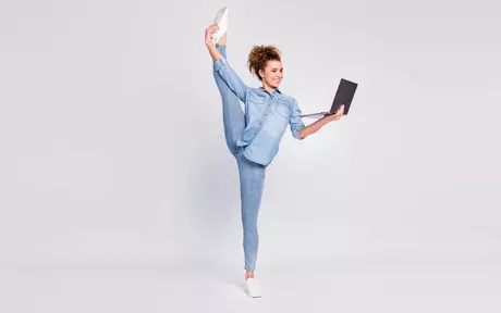 Flexible woman with laptop