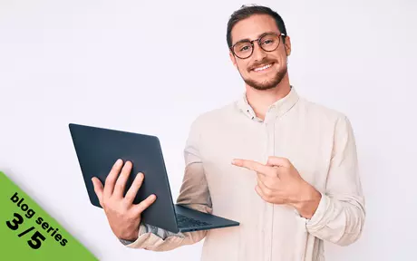 men pointing to a laptop