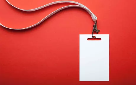 a plain white ID card on a white lanyard on a red background