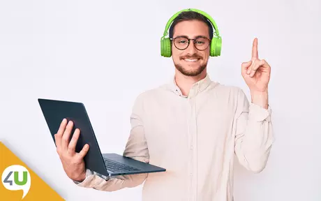 Smiling man with headphones and laptop