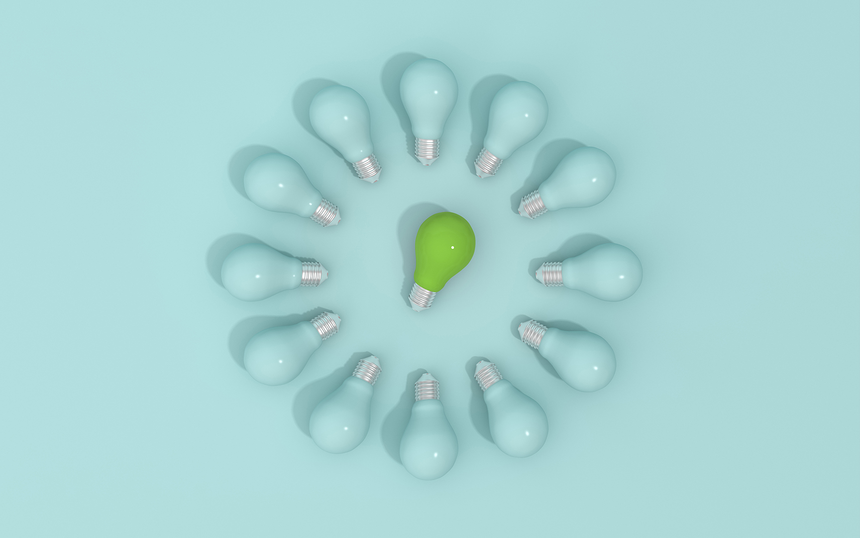 A circle of light bulbs with one green bulb in the center among blue ones