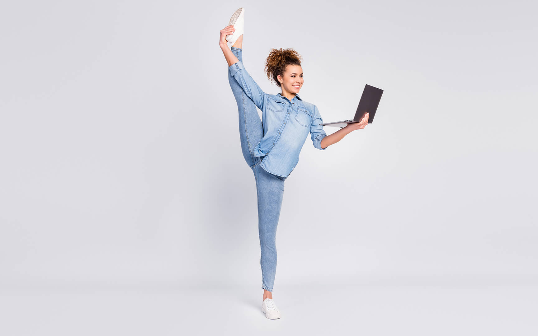 Flexible woman with laptop