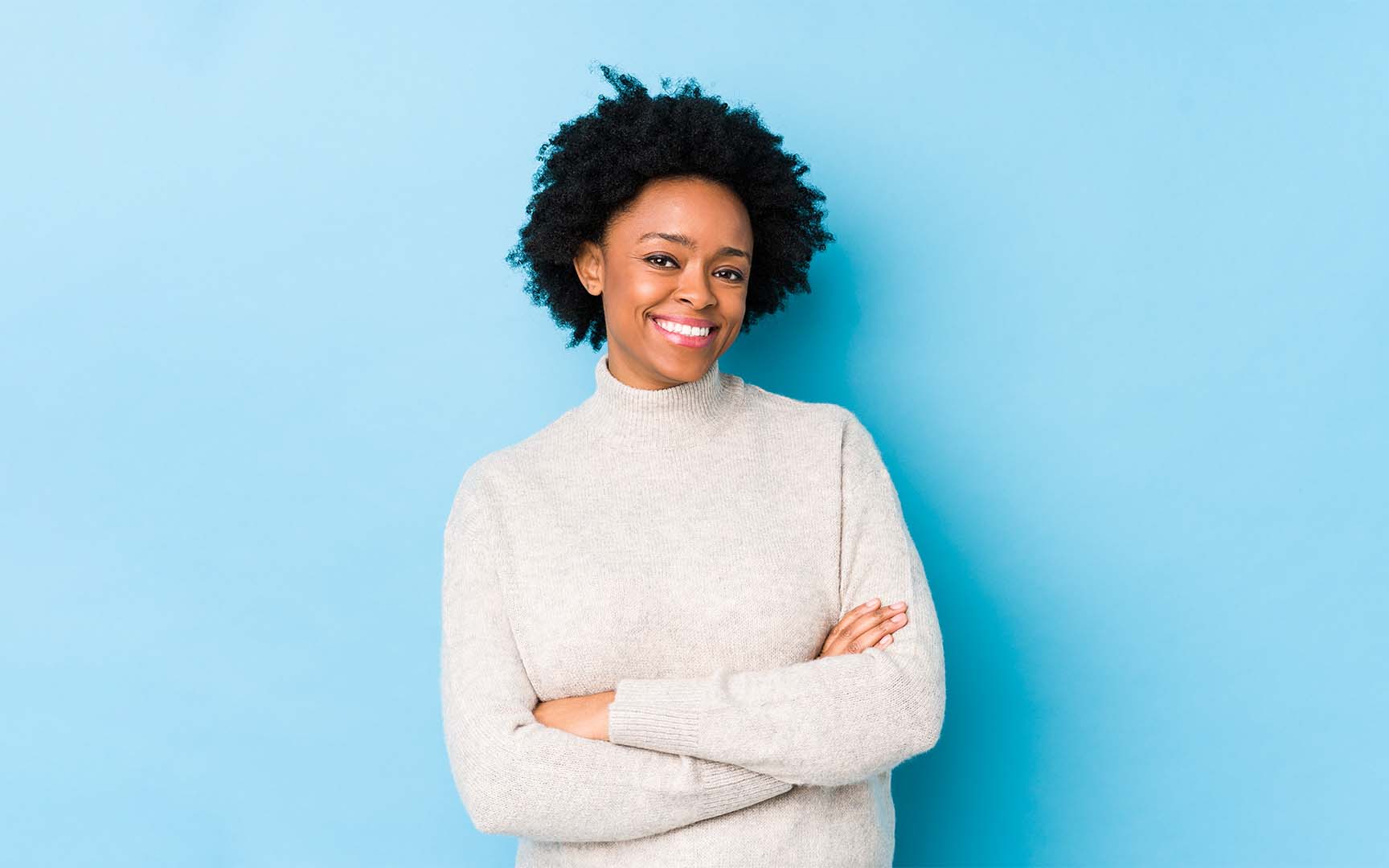 woman with white sweater and arms crossed