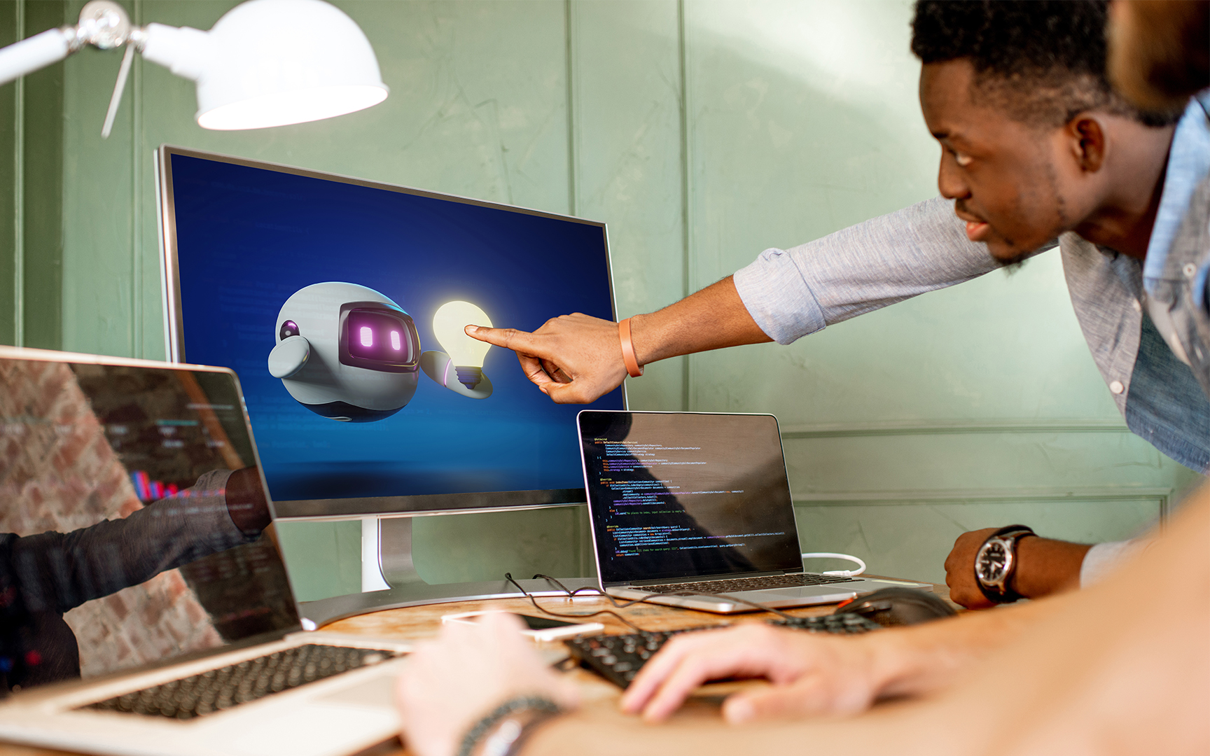 men pointing to a screen