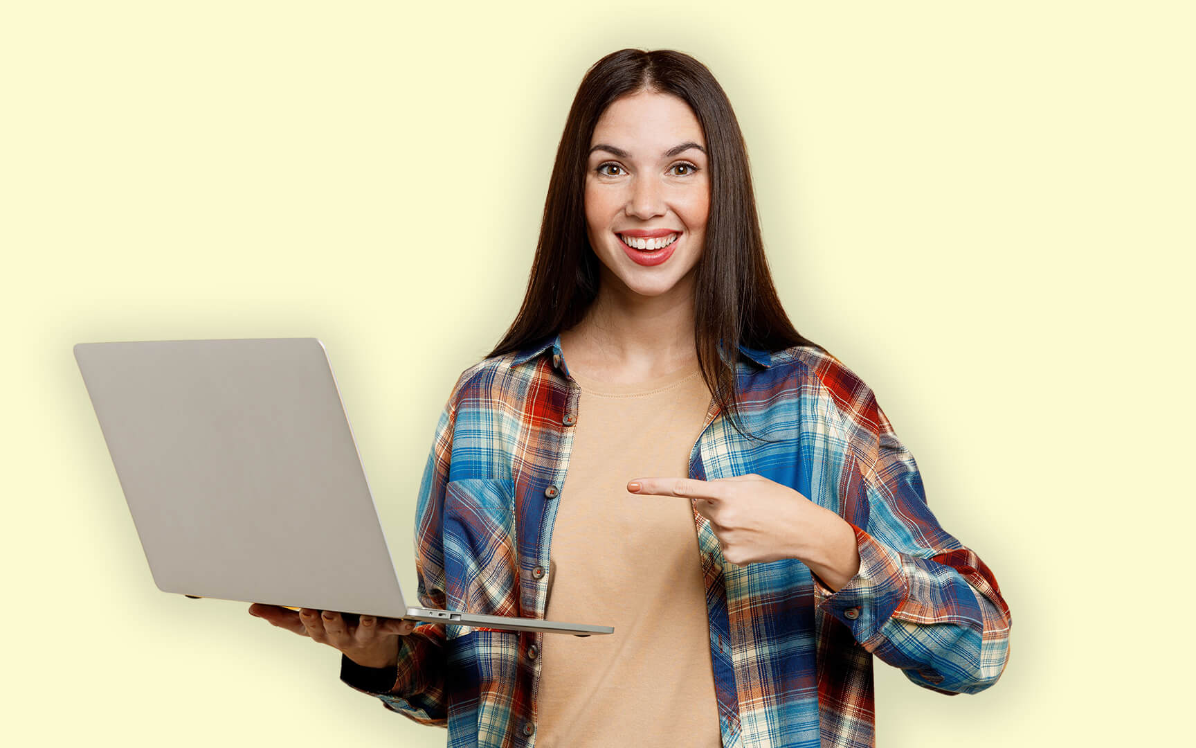 young woman pointing to laptop smiling