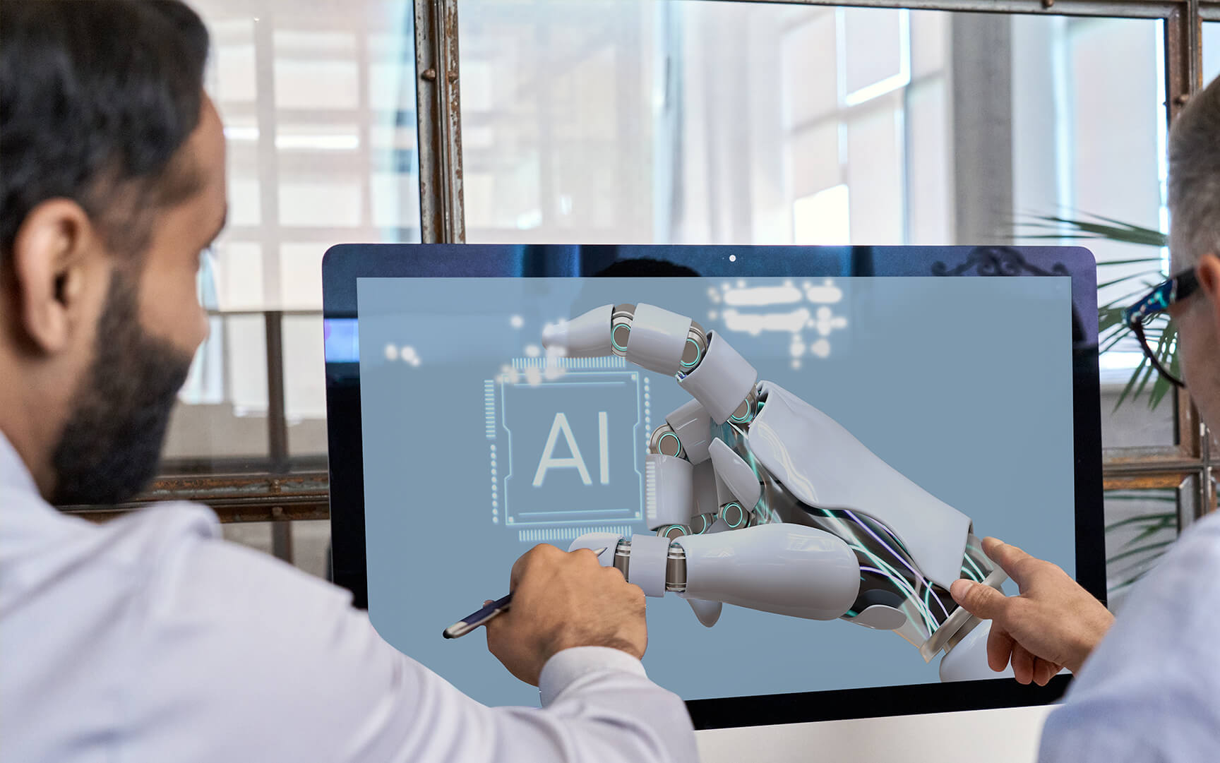 two men pointing to a computer