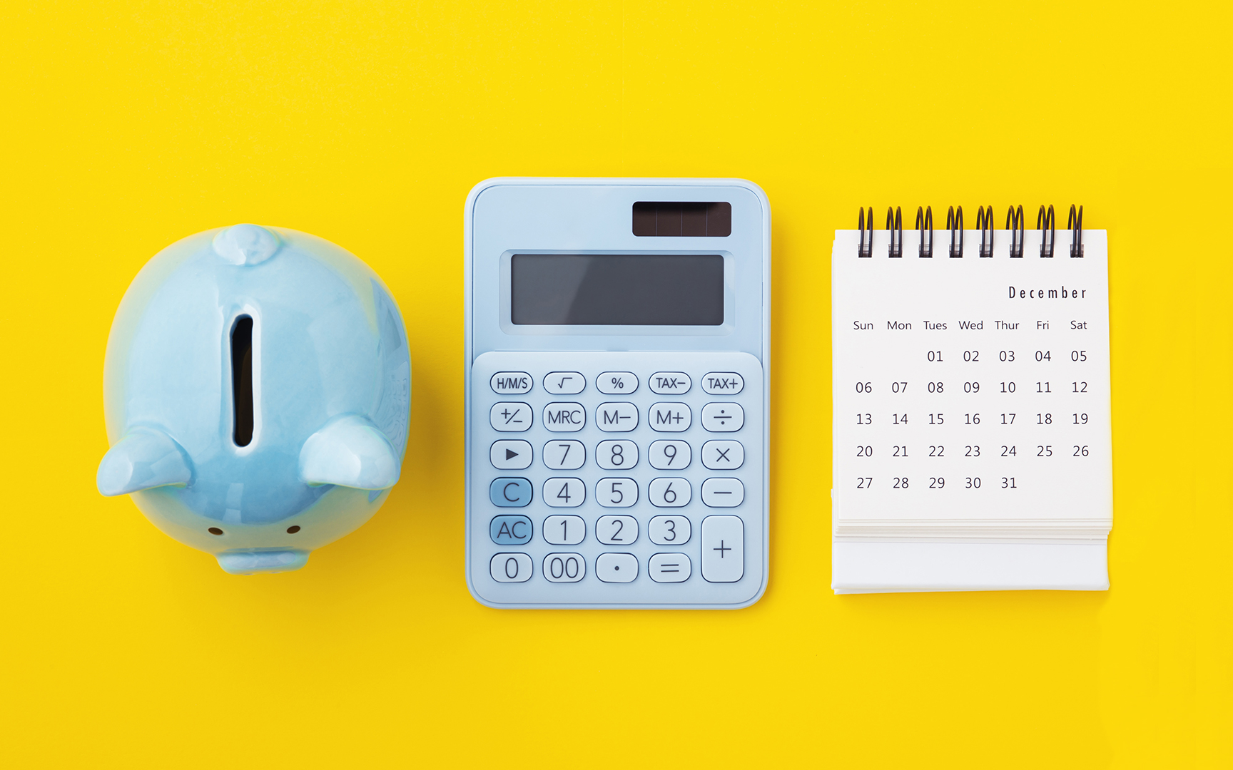 piggy bank, calculator and calendar