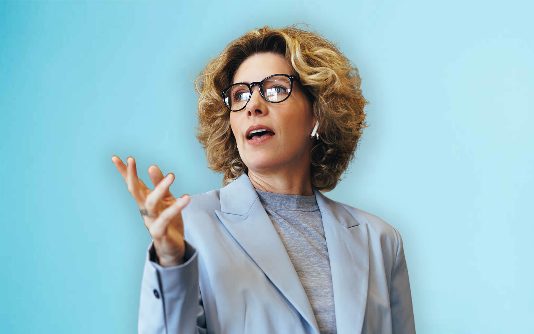 woman pointing with a blue background