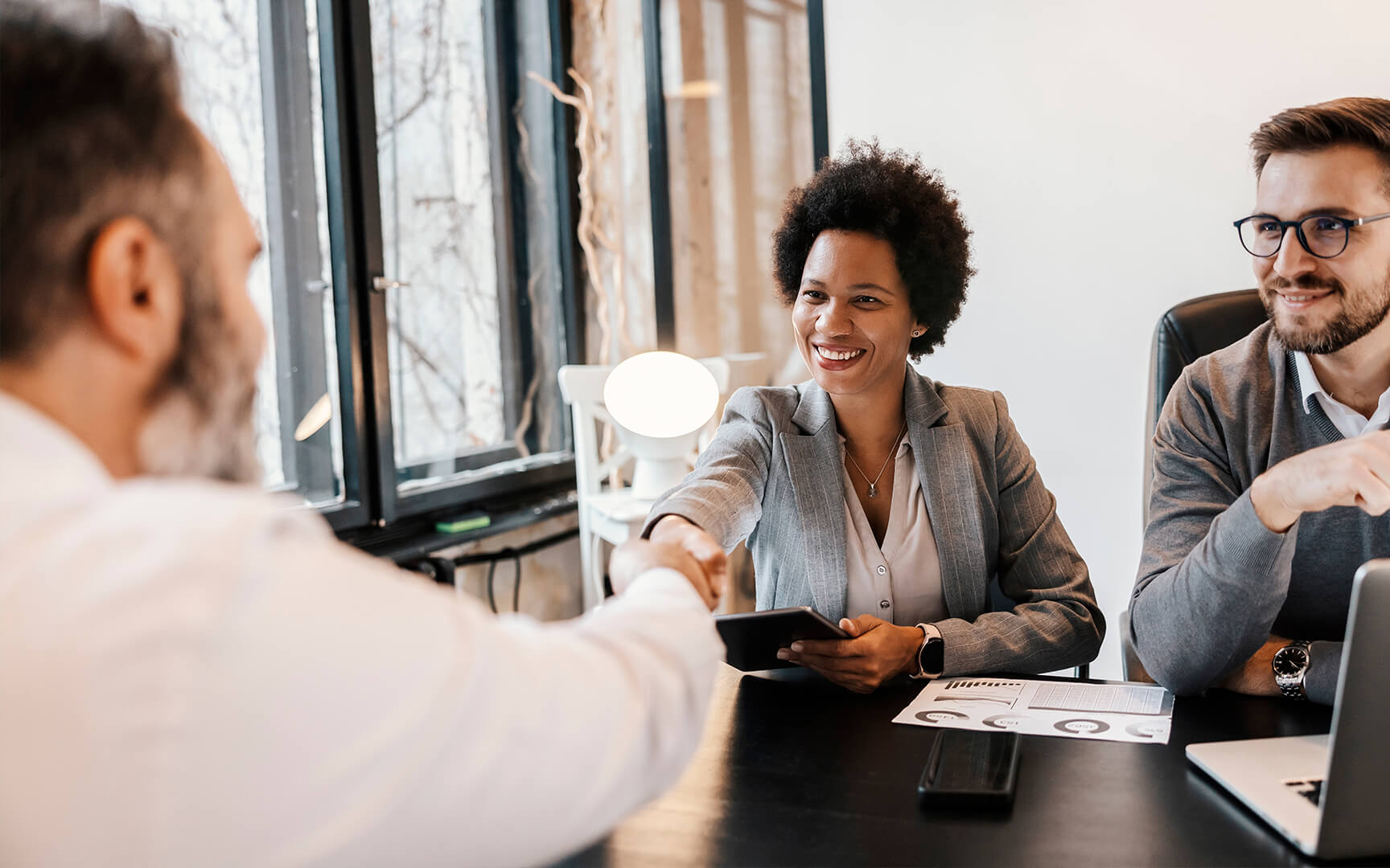 people sit at a table smiling