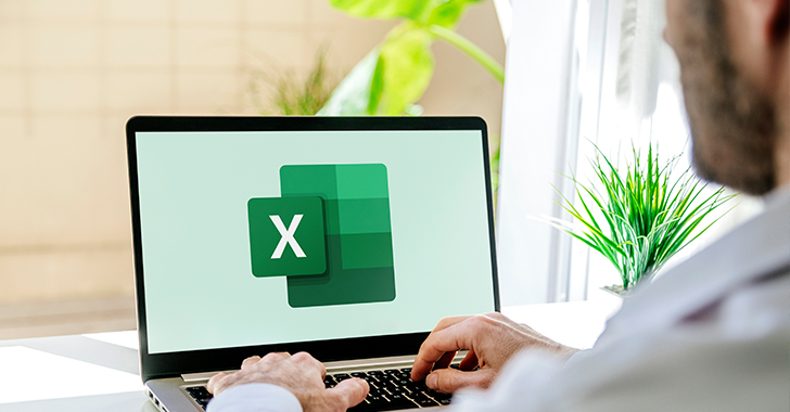 Over-the-shoulder view of a person using a silver laptop with the Microsoft Excel logo prominently displayed on the screen.