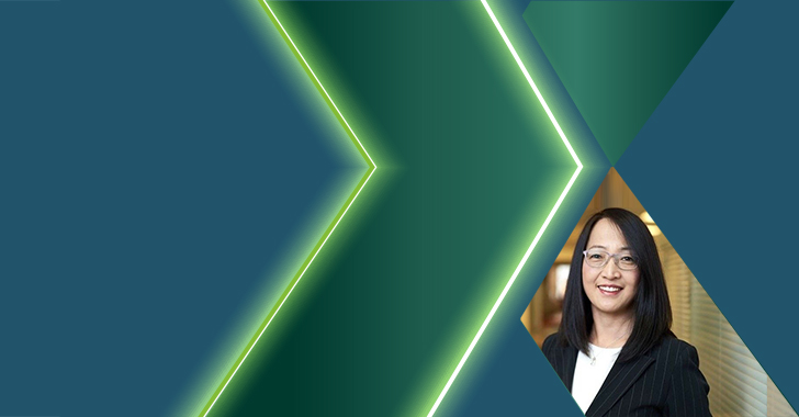 Portrait of an East Asian woman with shoulder-length black hair and glasses, wearing a dark pinstriped blazer over a white top.