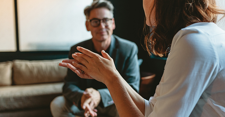 Close-up of a conversation in a softly lit room. 
