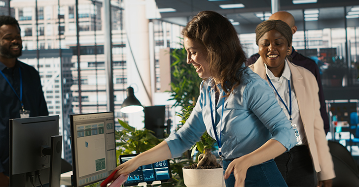 A bright, modern office scene with three colleagues.