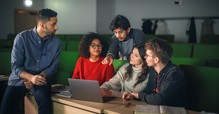 Five students collaborate in a university lecture hall. 