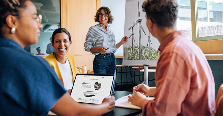 A diverse group of four professionals collaborates in a modern office. 