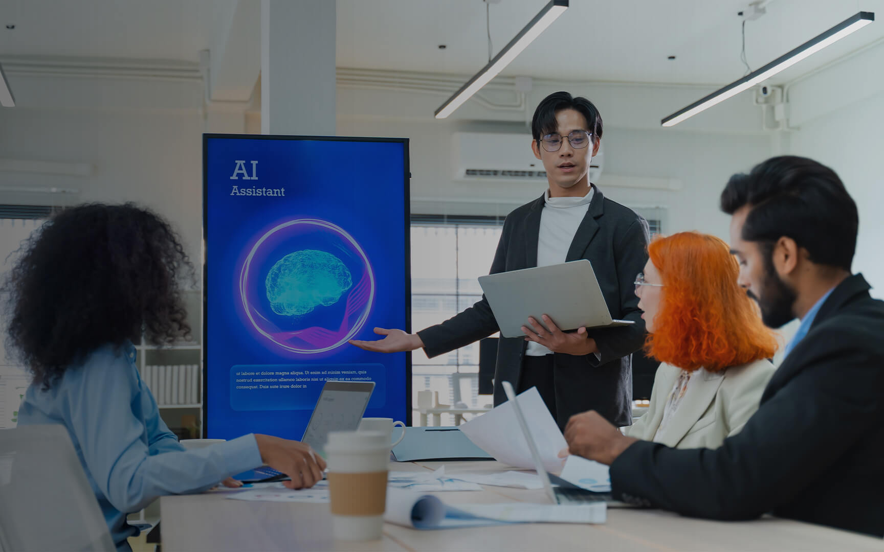 Team in a modern office reviewing an AI Assistant presentation, with a speaker explaining data insights on a large screen during a collaborative business meeting.