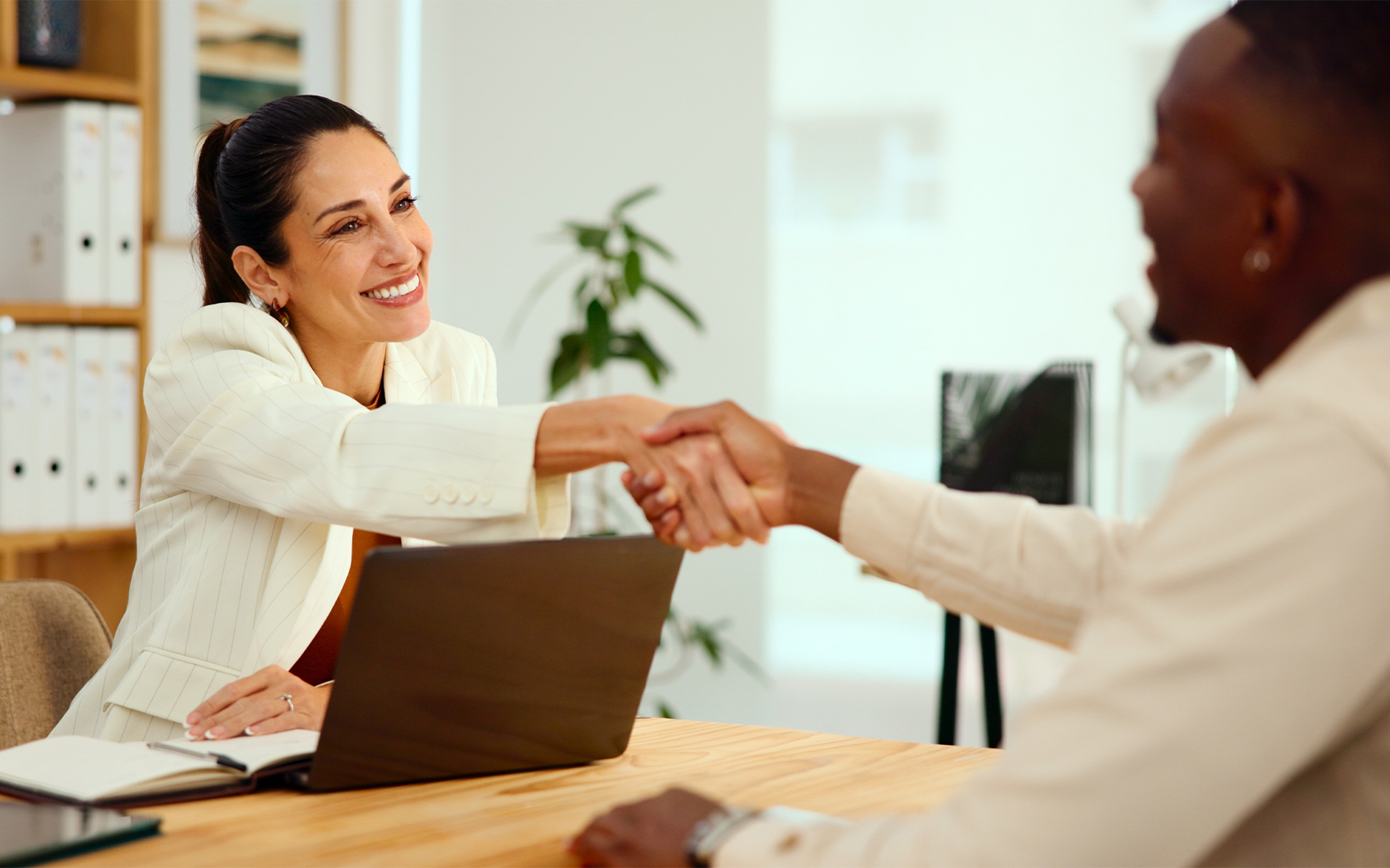 A professional onboarding or interview meeting in a modern office.