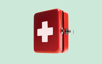 First aid kit on green background