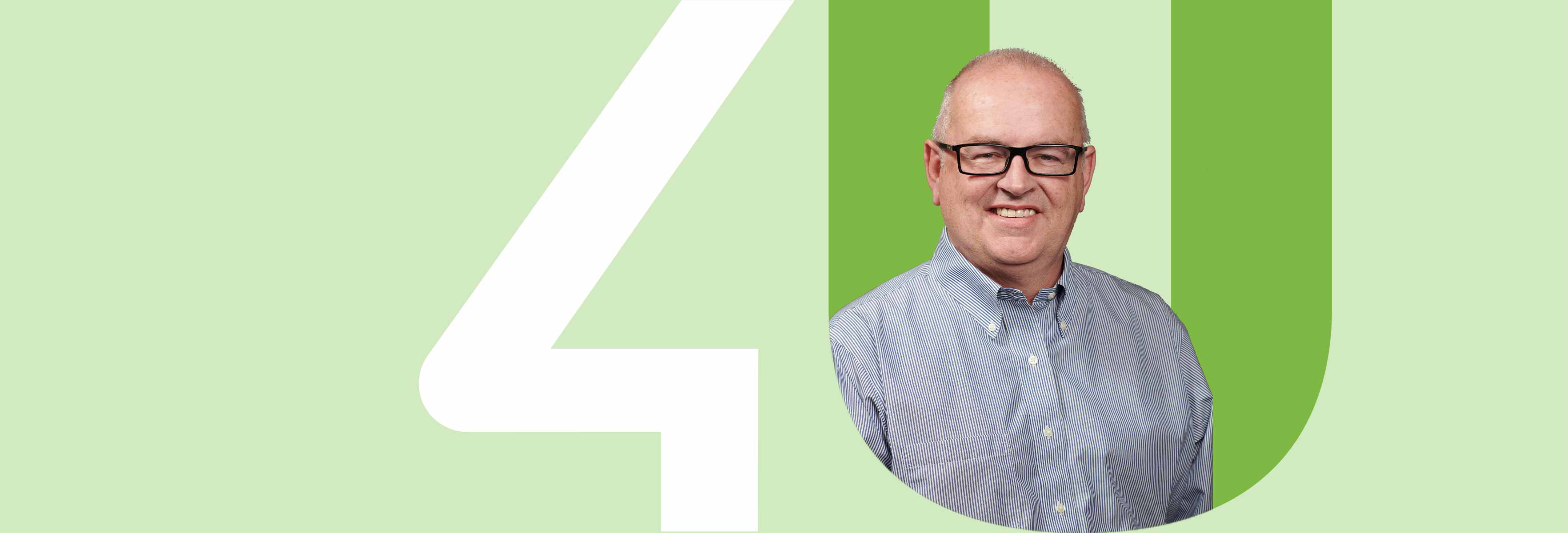 man with glasses inside the unit4 logo with green background