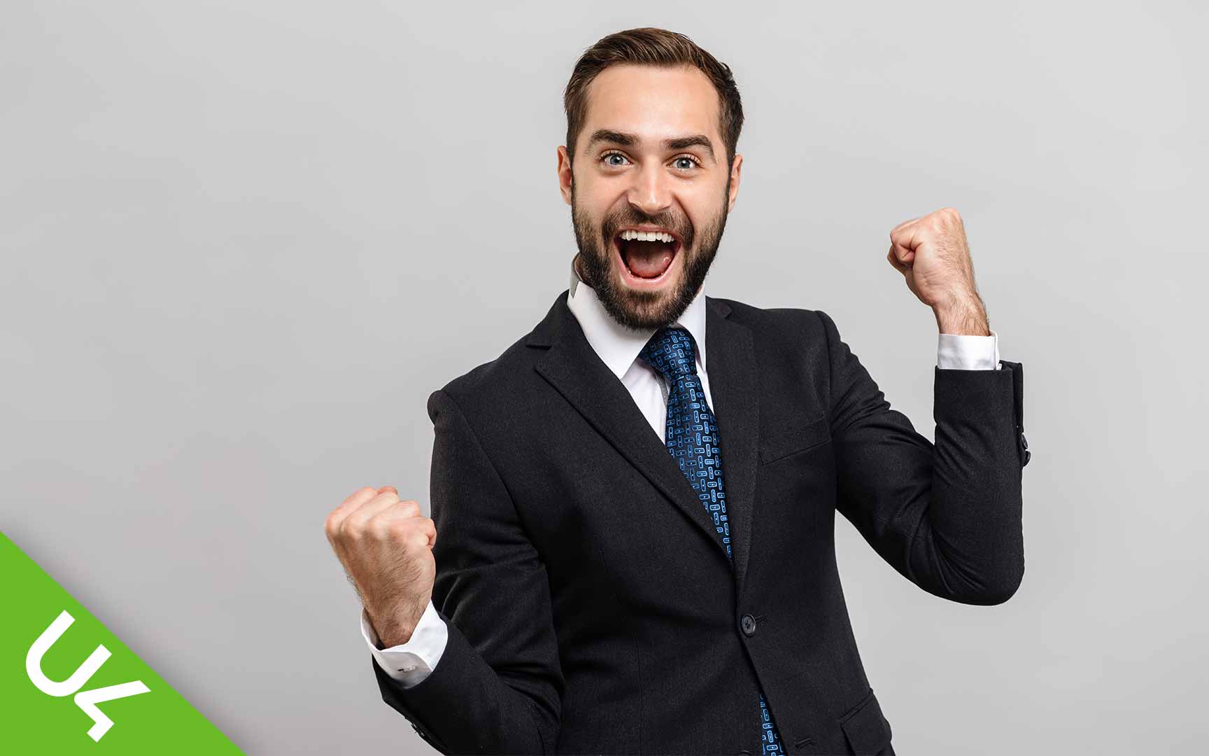 Man in suit, arms in the air, celebrating