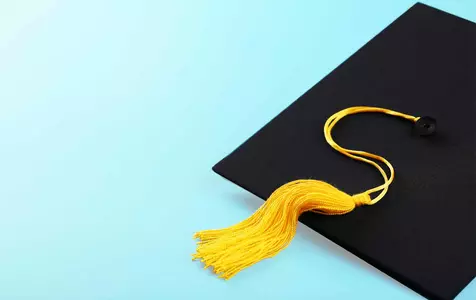 Graduation cap on a light blue background