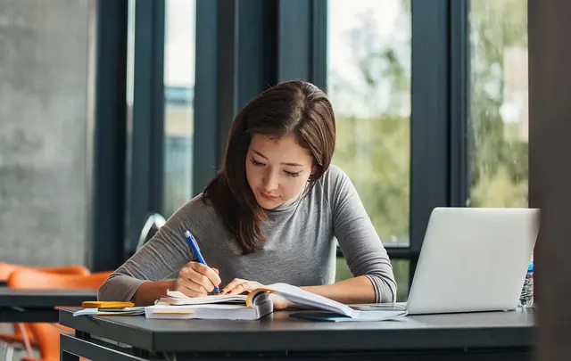 person studying with laptop