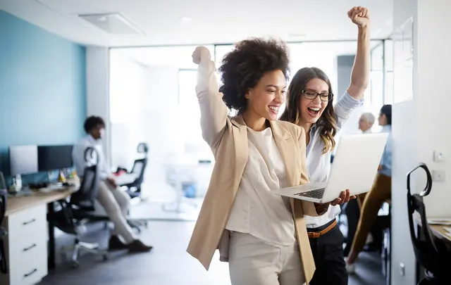 people holding laptop cheering, celebrating