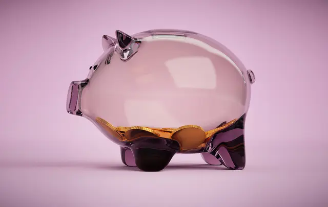 transparent piggy bank with coins