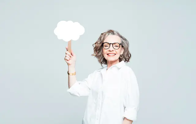 woman holding up cloud sign