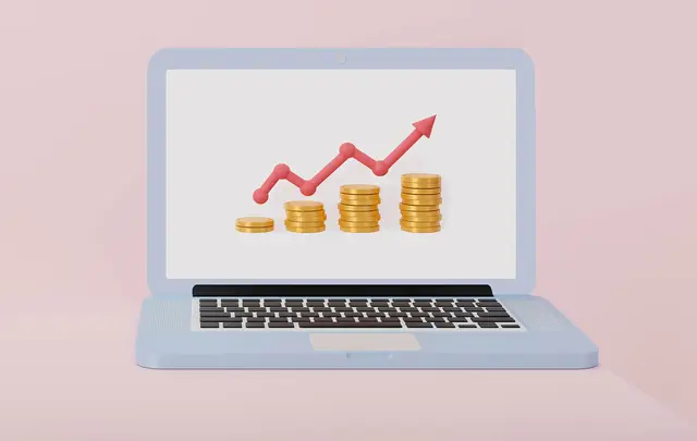 laptop with graph and coins