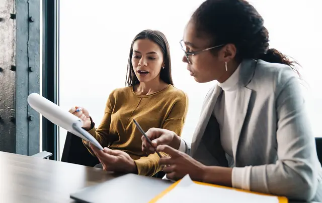 people looking at paper