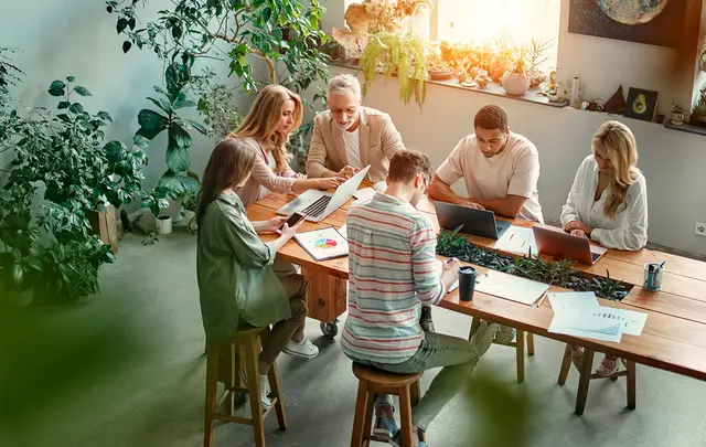 people working around table 