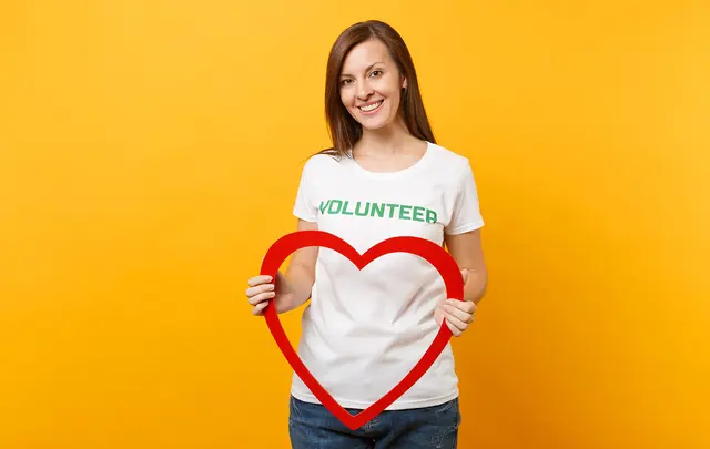 woman with volunteer tshirt and red heart