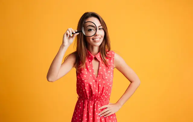 happy woman with magnifying glass