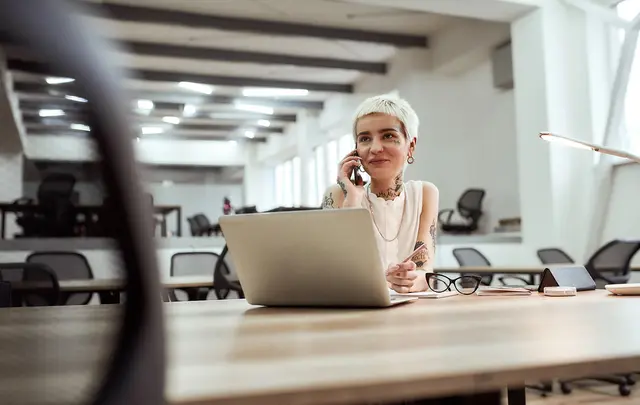 young tattooed business woman smiling