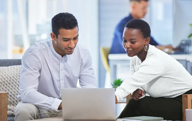 Businesspeople looking at laptop