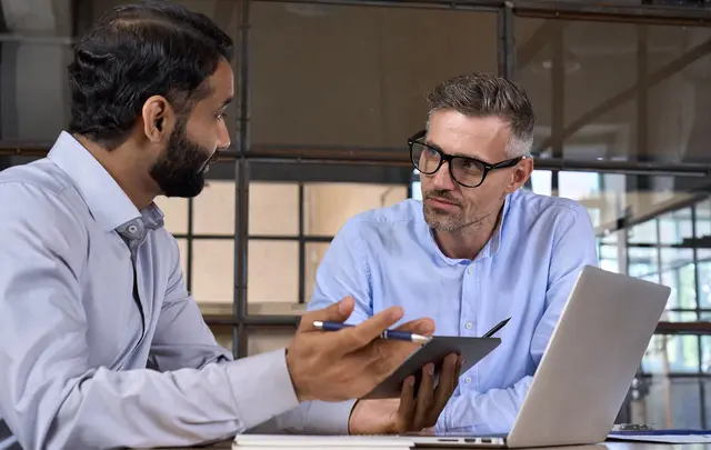 Men talking with laptop
