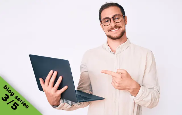 men pointing to a laptop