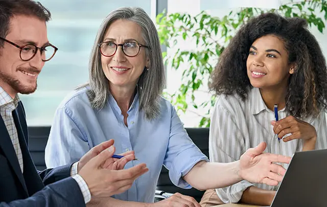 two women and one man in a meeting