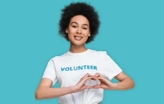 volunteer woman making heart with hands