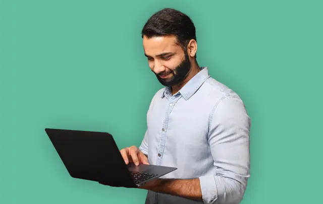 man with a laptop smiling