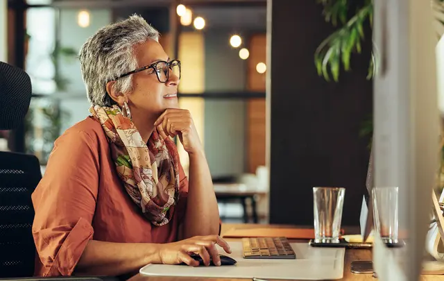 old woman sit in a desk