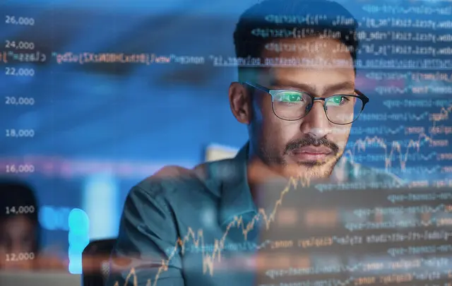 men working in front of a screen
