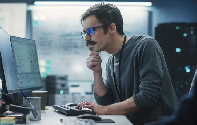 men sitting in front of a computer