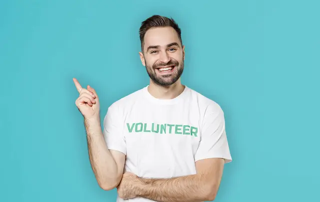 men pointing using a volunteer t-shirt