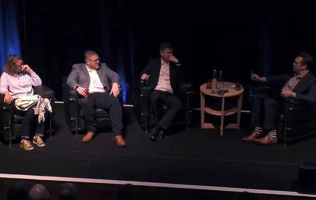 people speaking in a conference