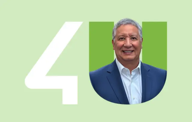 A person in a dark blue suit framed within a green 'U' next to a white '4' on a light green background.